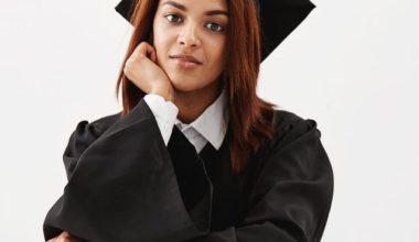 african-female-graduate-cap-mantle-smiling-sitting-with-books-4